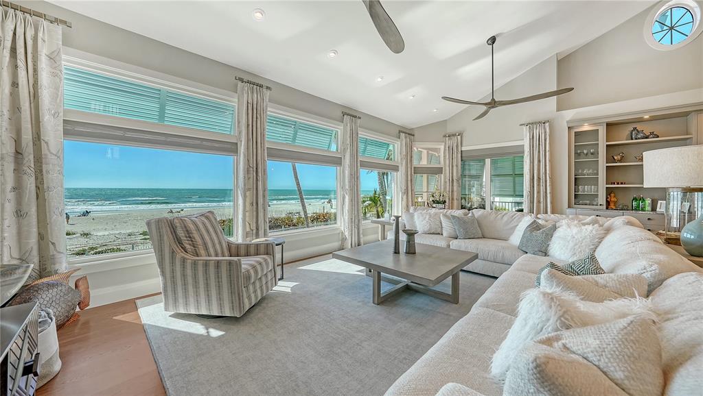 95 52nd Street Holmes Beach, FL 34217 - Photo 9 of 73 a living room with furniture and floor to ceiling windows