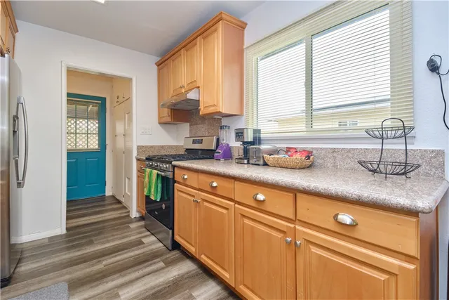 a kitchen with granite countertop a sink and a window
