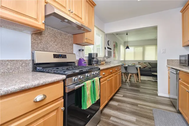 a kitchen with stainless steel appliances granite countertop a stove and a sink