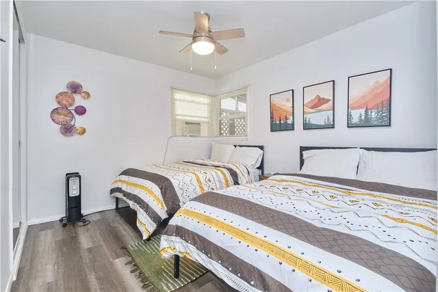 a bedroom with two beds and a chandelier