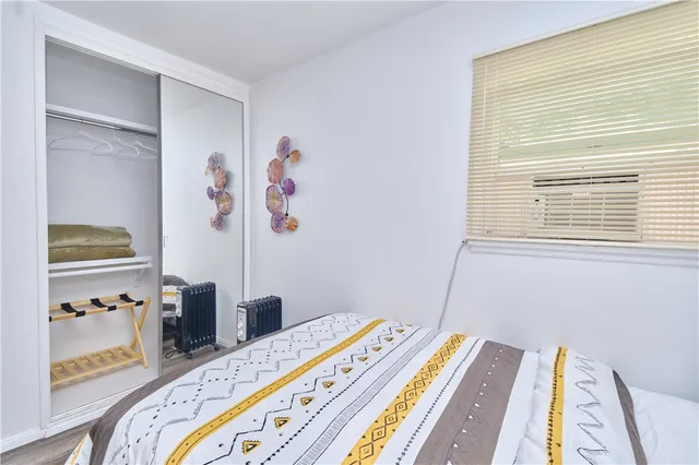 a bedroom with a bed and a window