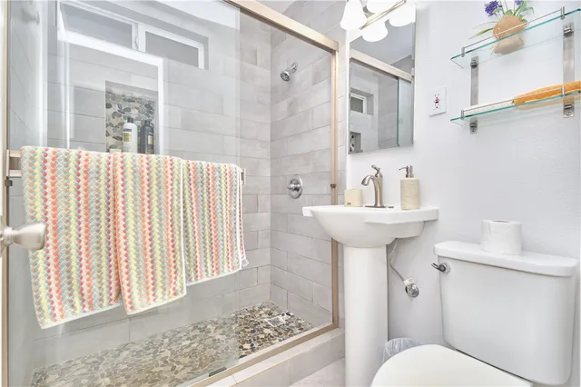 a bathroom with a sink toilet and shower