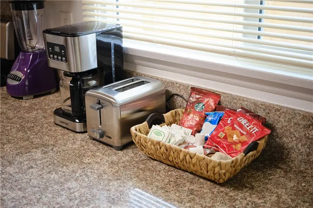 a living room with furniture and a baby crib
