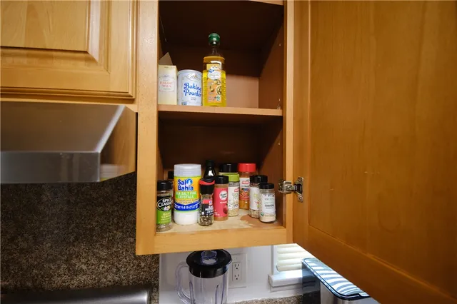 a view of an outdoor sitting area with chairs and umbrella