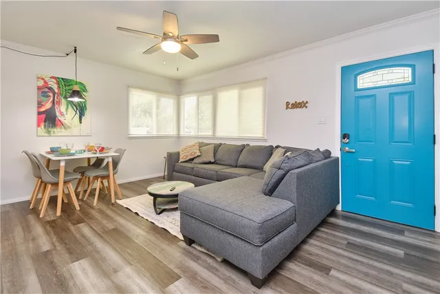 a living room with furniture a chandelier and a window