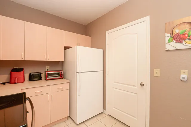 a kitchen with a refrigerator a stove a microwave and cabinets