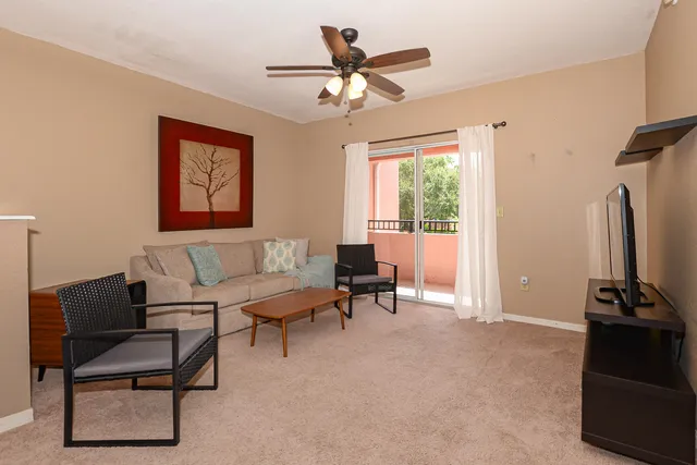 a living room with furniture a window and a chandelier