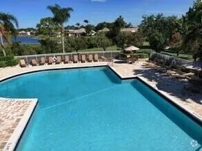 swimming pool view with a seating space
