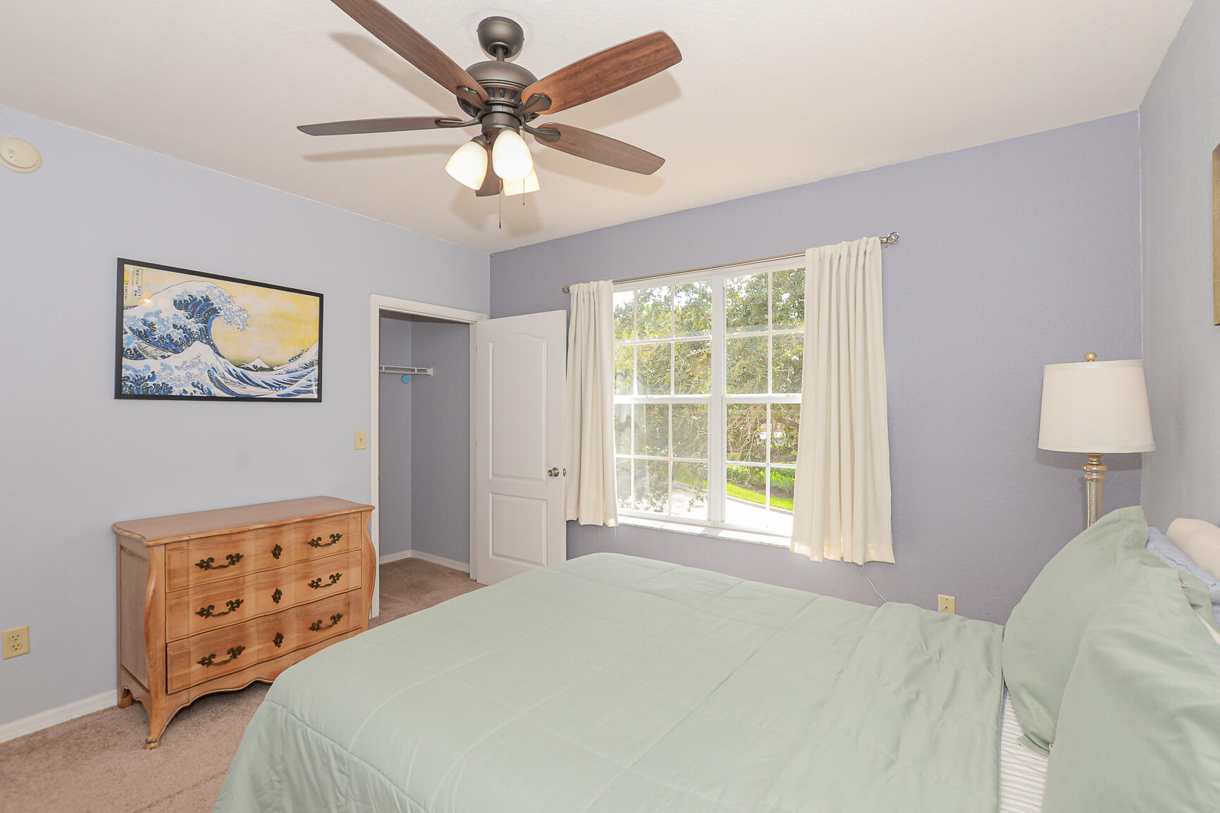 106 Southwest Peacock Boulevard, Unit 4204 Port St. Lucie, FL 34986 - Photo 26 of 47 a bedroom with double bed and a window