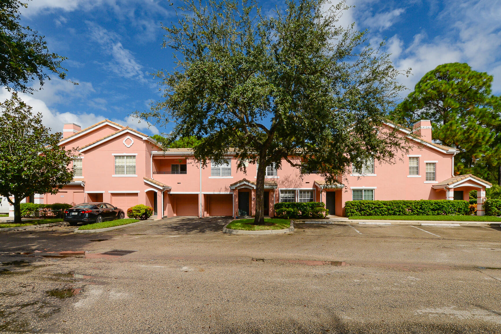 106 Southwest Peacock Boulevard, Unit 4204 Port St. Lucie, FL 34986 - Photo 3 of 47 a front view of a house with a garden