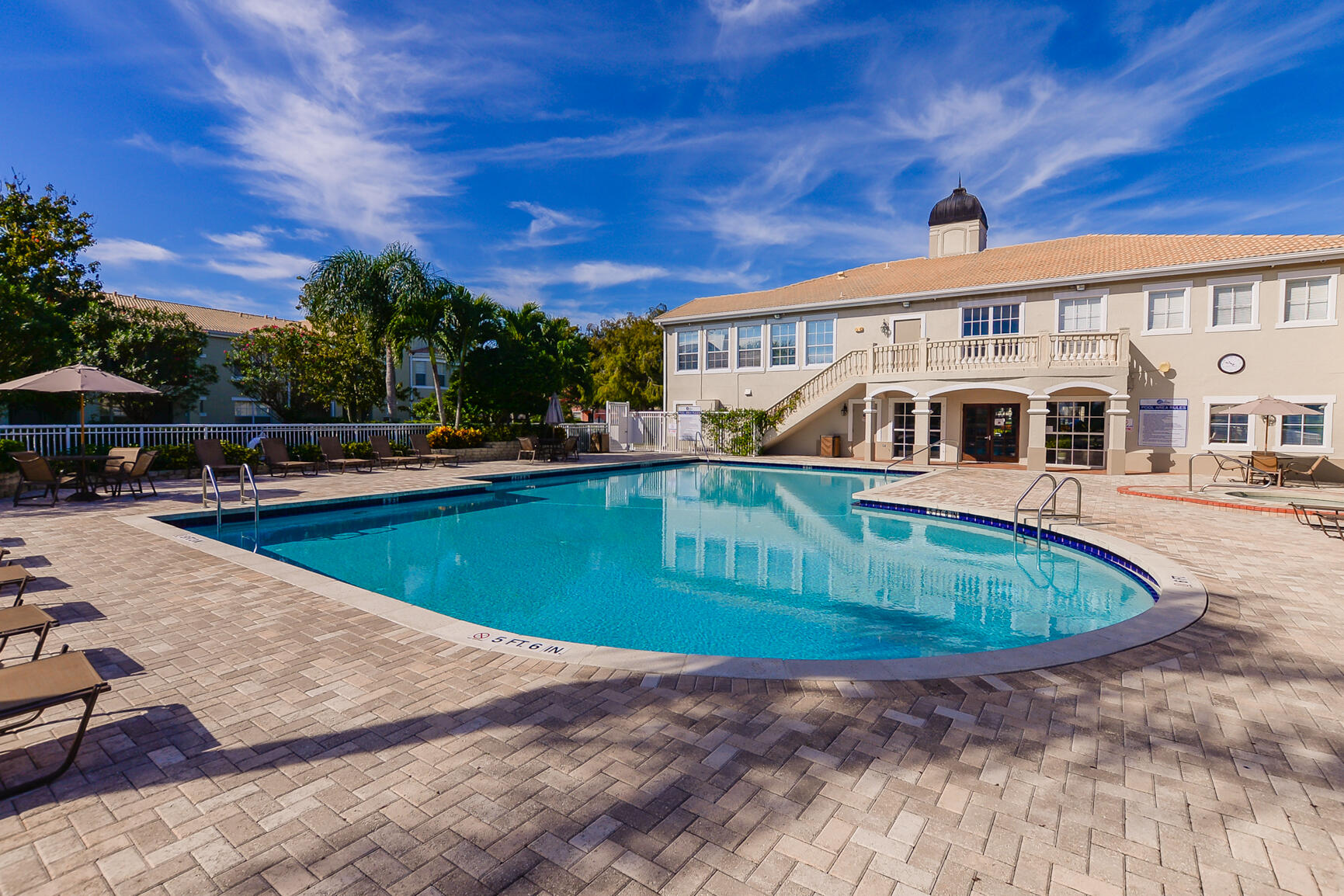 106 Southwest Peacock Boulevard, Unit 4204 Port St. Lucie, FL 34986 - Photo 33 of 47 a view of a swimming pool with an outdoor seating