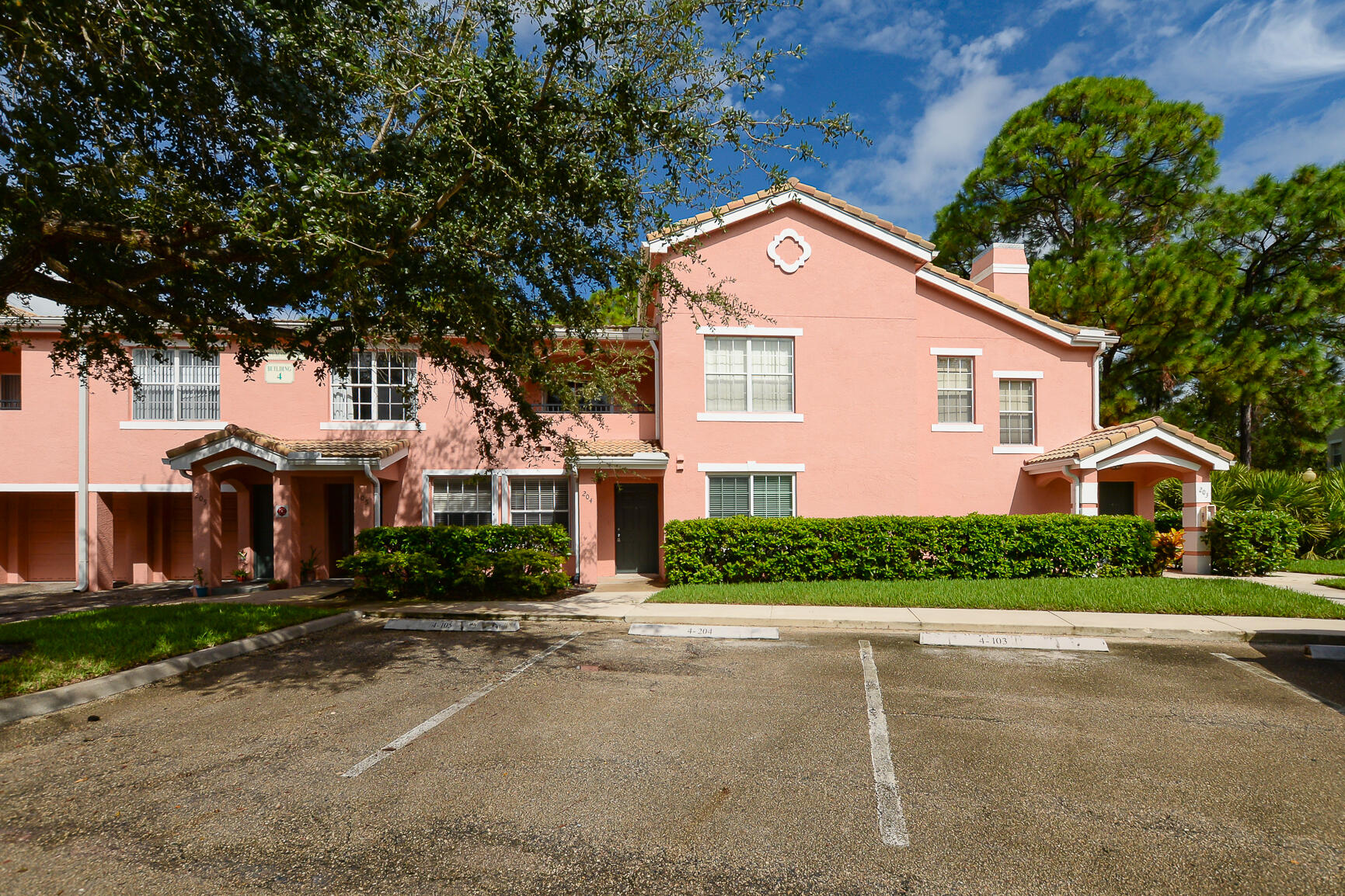 106 Southwest Peacock Boulevard, Unit 4204 Port St. Lucie, FL 34986 - Photo 4 of 47 a front view of a house with a yard
