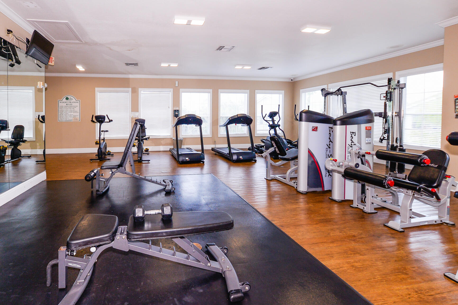 106 Southwest Peacock Boulevard, Unit 4204 Port St. Lucie, FL 34986 - Photo 43 of 47 a gym room with lots of gym equipment
