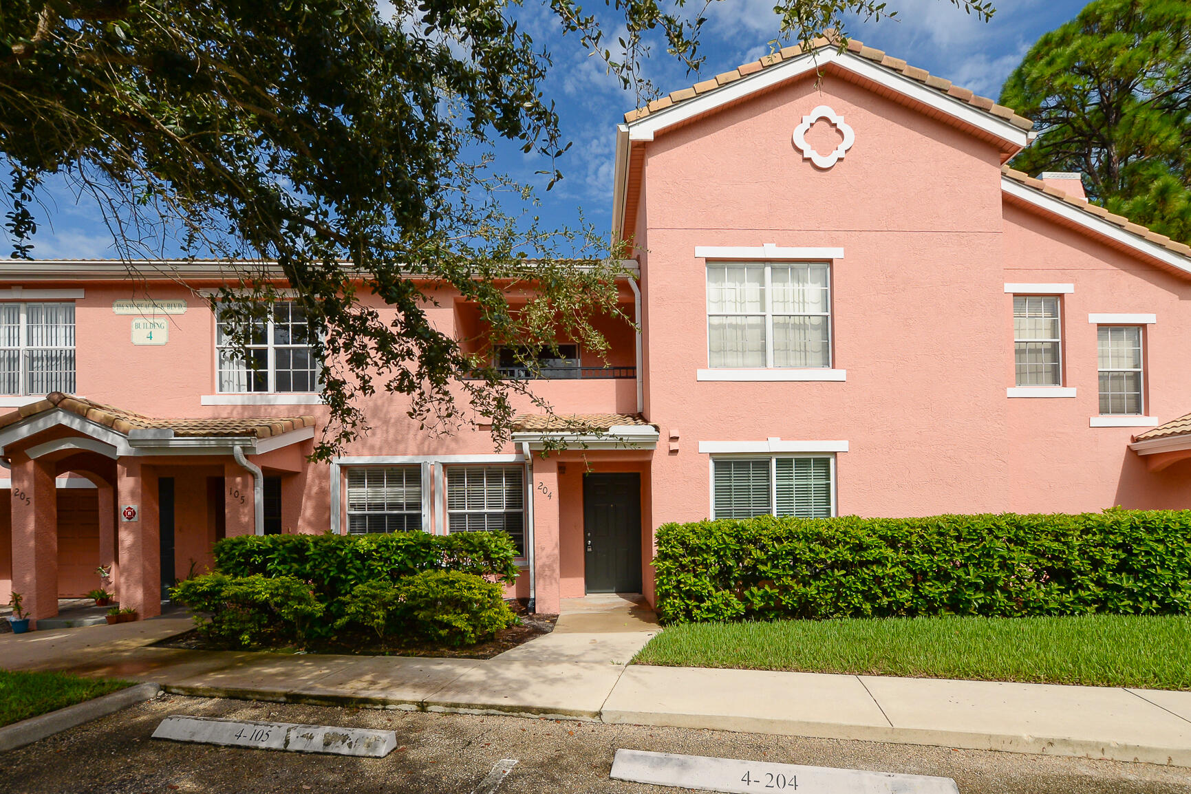 106 Southwest Peacock Boulevard, Unit 4204 Port St. Lucie, FL 34986 - Photo 5 of 47 a front view of a house with garden
