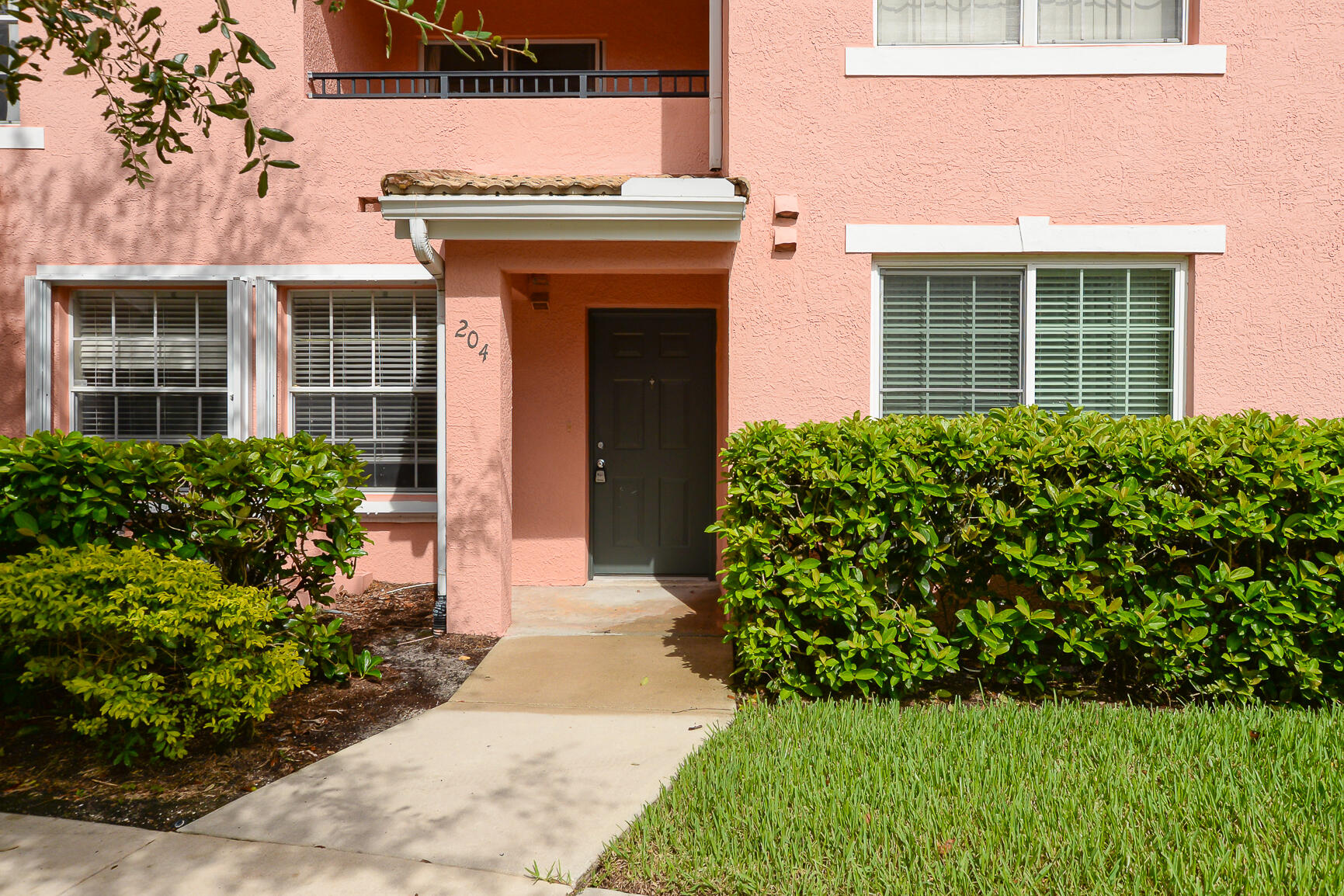 106 Southwest Peacock Boulevard, Unit 4204 Port St. Lucie, FL 34986 - Photo 6 of 47 front view of a house with a yard