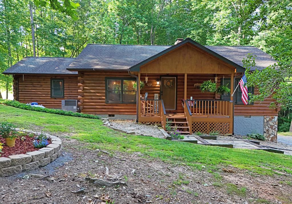 90 Log Cabin Road Blairsville, GA 30512 - Photo 1 of 45 a front view of a house with garden