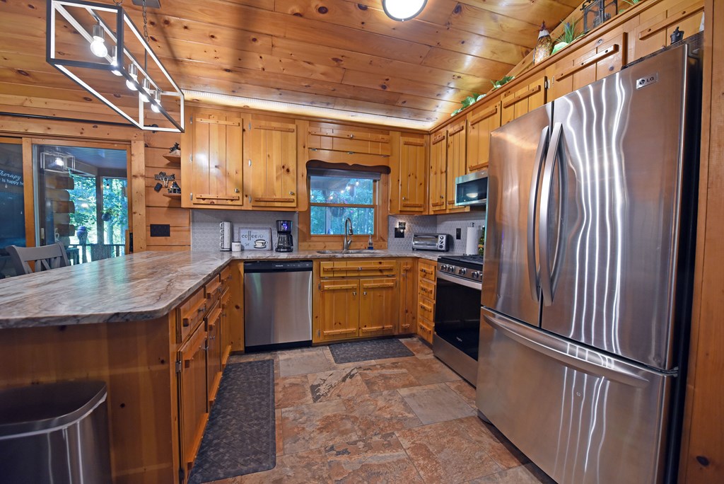 90 Log Cabin Road Blairsville, GA 30512 - Photo 13 of 45 a kitchen with granite countertop a refrigerator stove and sink