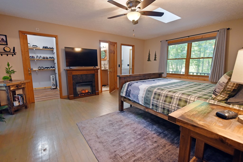 90 Log Cabin Road Blairsville, GA 30512 - Photo 15 of 45 a bedroom with a bed and a flat screen tv
