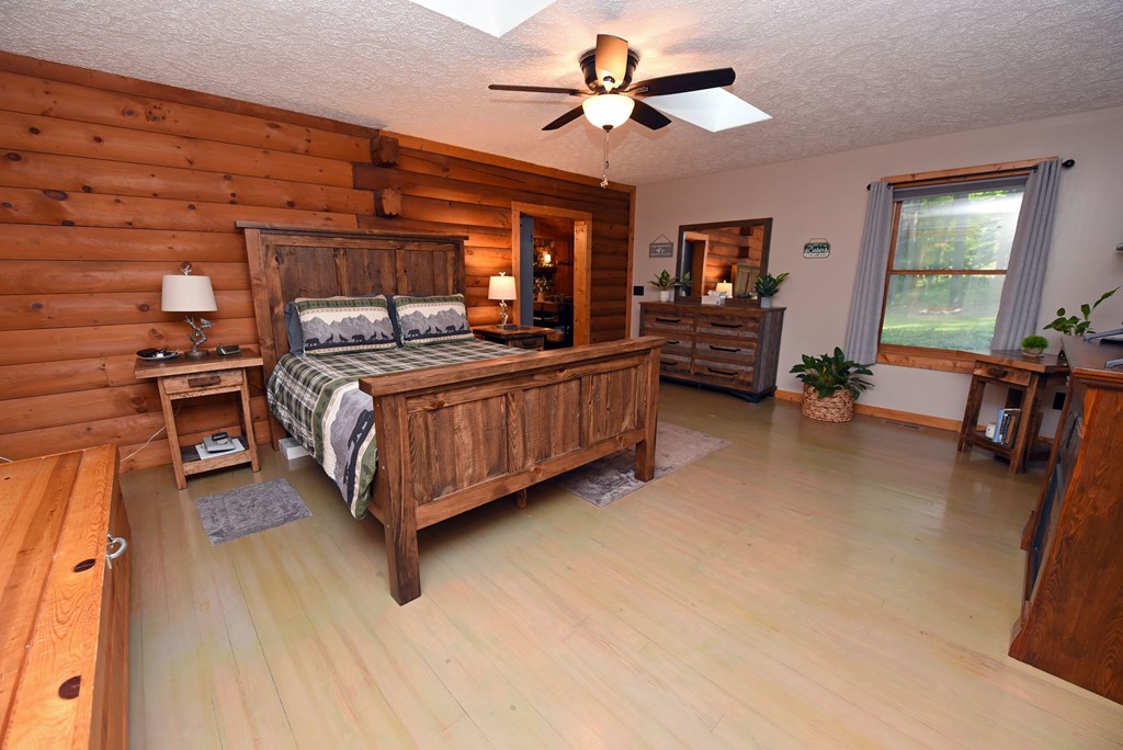90 Log Cabin Road Blairsville, GA 30512 - Photo 21 of 45 a living room with furniture a ceiling fan and a window