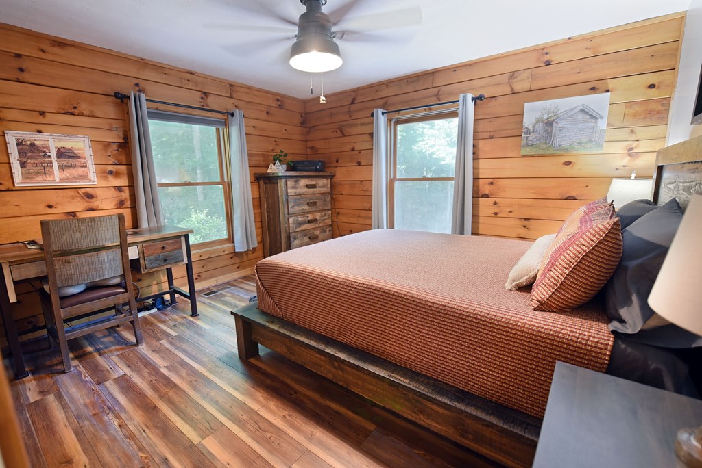 90 Log Cabin Road Blairsville, GA 30512 - Photo 28 of 45 a bedroom with a bed wooden floor and window