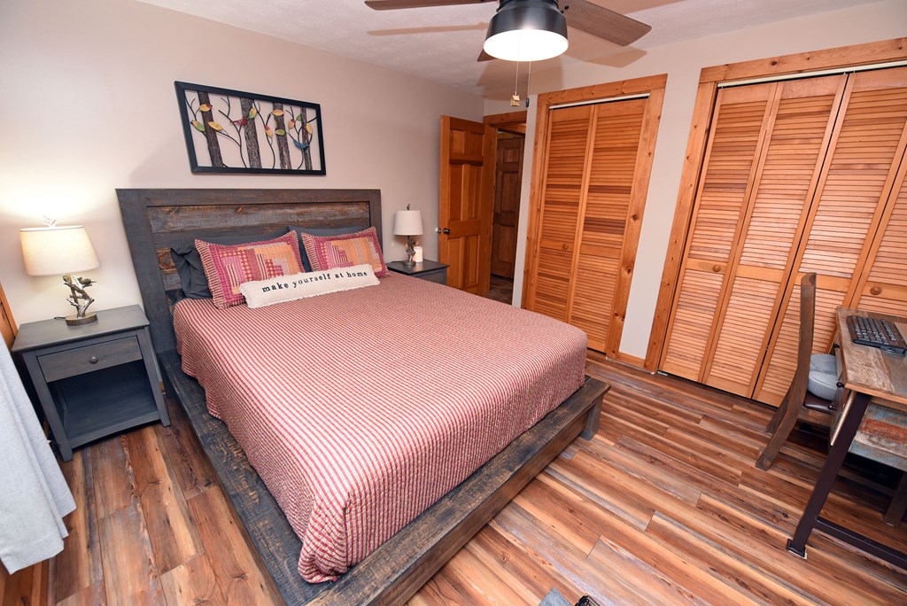 90 Log Cabin Road Blairsville, GA 30512 - Photo 29 of 45 a bedroom with a bed and wooden floor