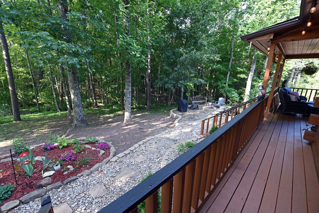 90 Log Cabin Road Blairsville, GA 30512 - Photo 43 of 45 a view of a house with wooden deck and a garden