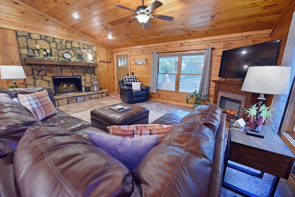 90 Log Cabin Road Blairsville, GA 30512 - Photo 9 of 45 a living room with furniture a fireplace and a flat screen tv