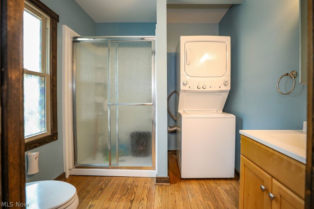 728 East Riddle Avenue Ravenna, OH 44266 - Photo 19 of 40 Bathroom featuring a wealth of natural light, wood-type flooring, toilet, and stacked washer / drying machine