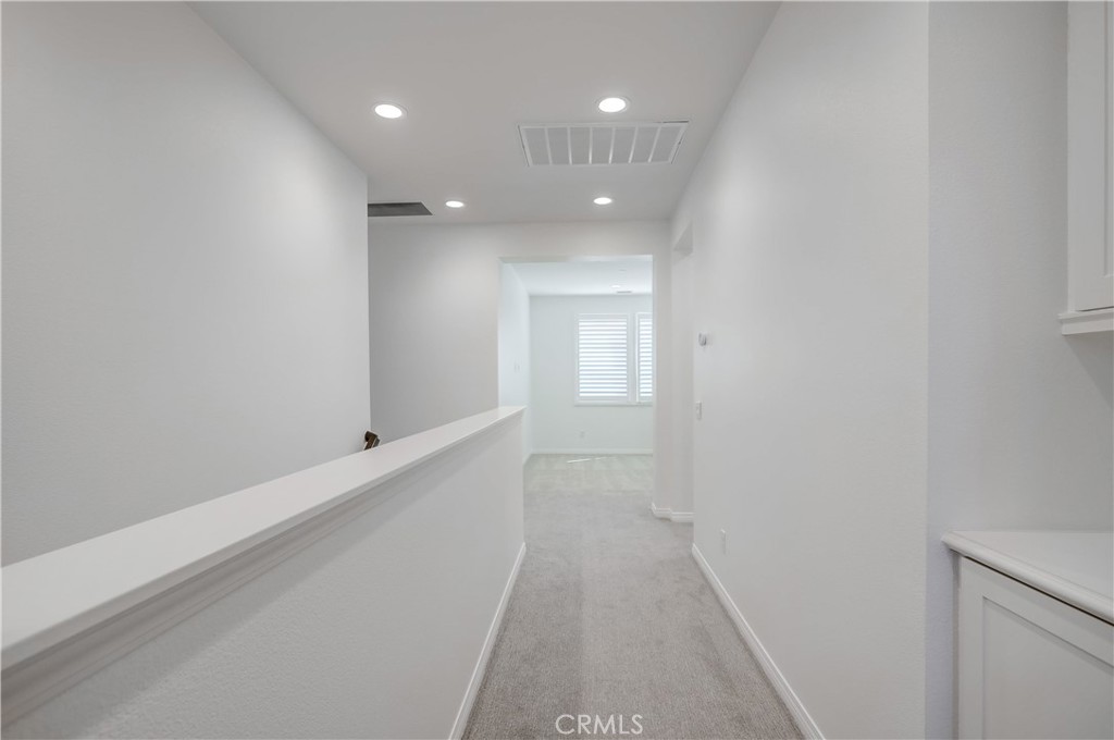 138 Brambles Irvine, CA 92618 - Photo 16 of 39 a view of a hallway with wooden floor