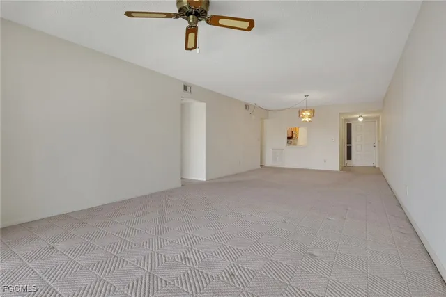 a view of a room with a ceiling fan