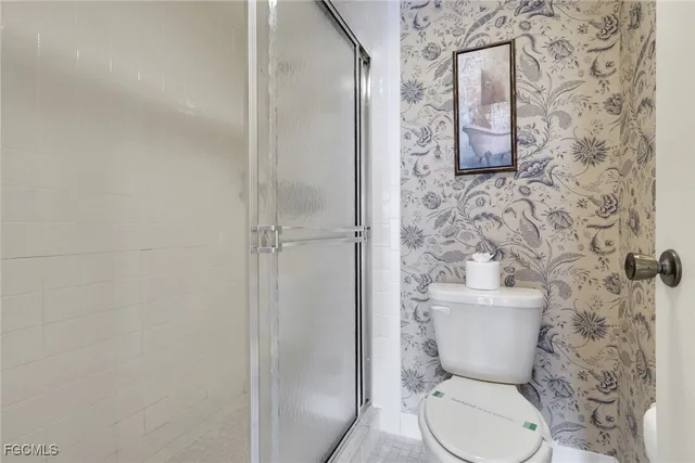a white toilet sitting next to a bathroom sink