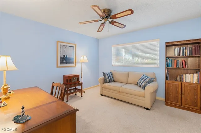 a living room with furniture and a book shelf