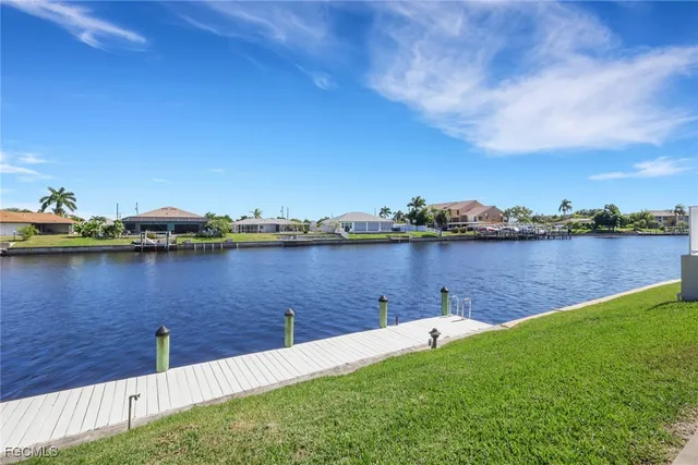 a view of a lake with houses in the back