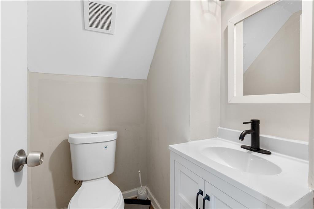 4485 Spring Valley Parkway Atlanta, GA 30349 - Photo 20 of 24 a bathroom with a toilet sink and mirror