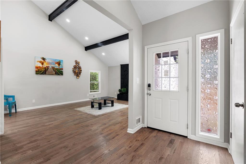 4485 Spring Valley Parkway Atlanta, GA 30349 - Photo 6 of 24 an empty room with wooden floor and windows