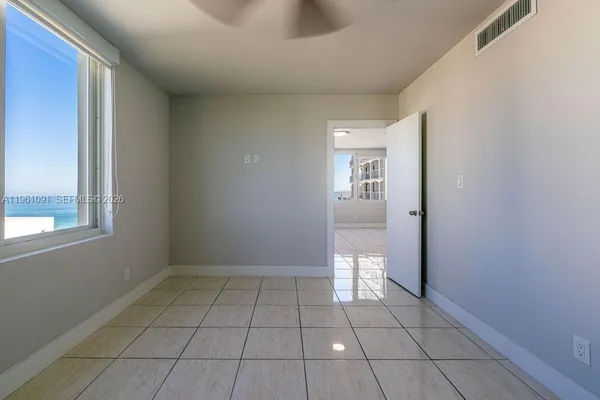 a view of an empty room with a mirror