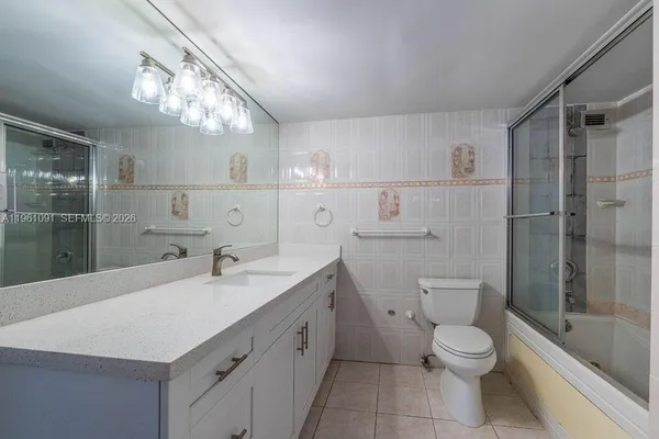 a bathroom with a glass door shower