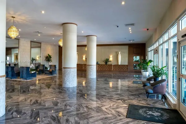 a lobby with furniture and floor to ceiling window