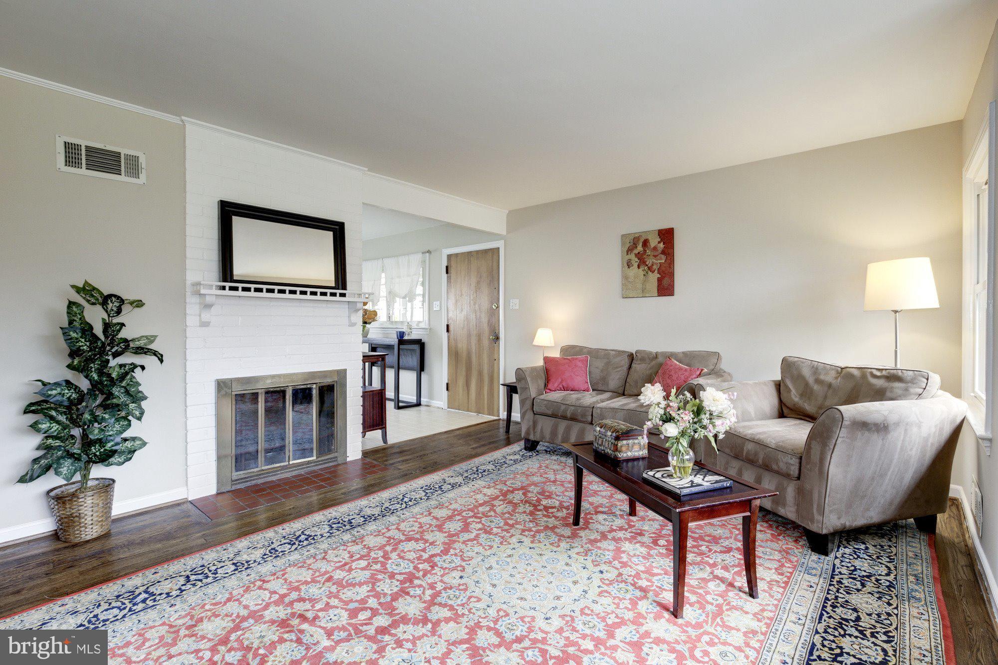 2802 Dawson Avenue Silver Spring, MD 20902 - Photo 11 of 30 a living room with furniture and a fireplace