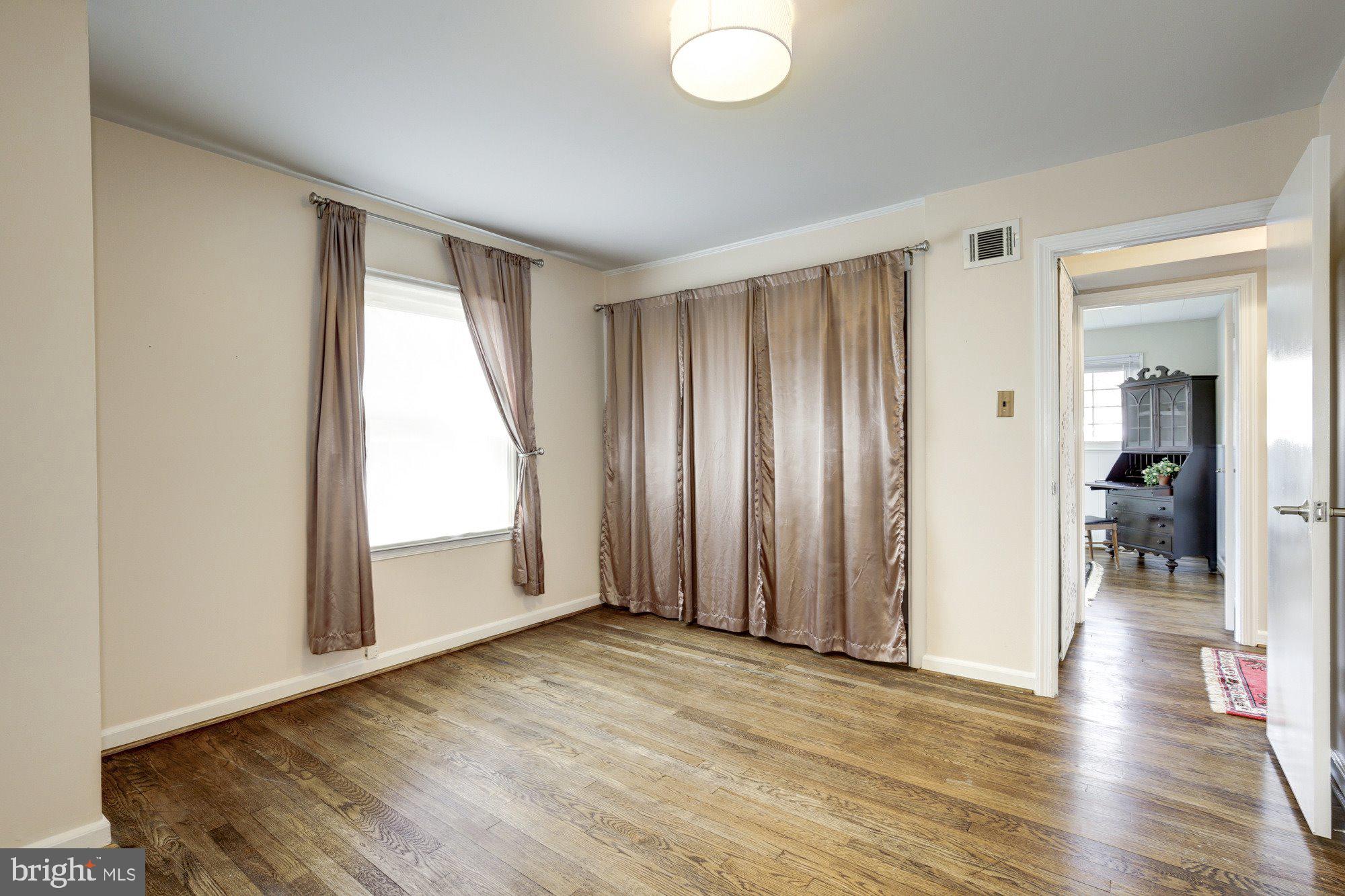 2802 Dawson Avenue Silver Spring, MD 20902 - Photo 19 of 30 an empty room with wooden floor and windows