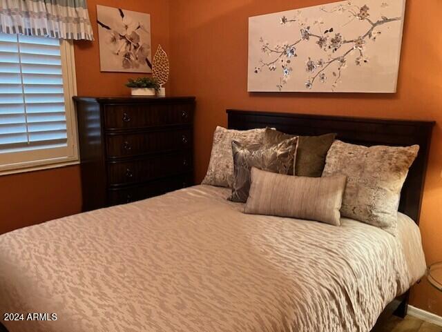 13622 West Merrell Street Avondale, AZ 85392 - Photo 12 of 15 a bed sitting in a bedroom with a black white comforter and pillows