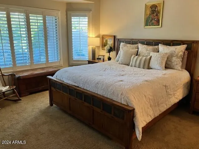 a bed sitting in a bedroom next to a window
