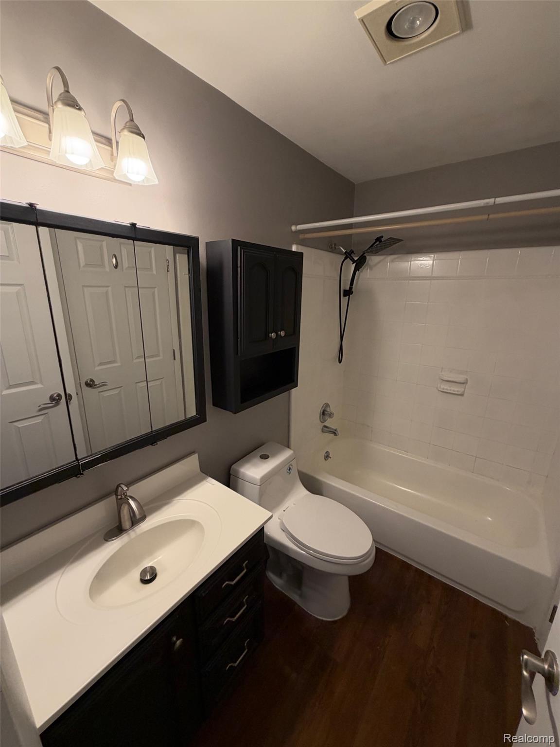 24525 Jamestowne Road Novi, MI 48375 - Photo 14 of 20 Vanity with integrated sink, wood-finish flooring, built-in medicine cabinet, and a shower-tub combination