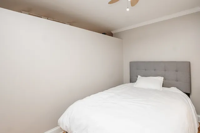 a bedroom with a white bed