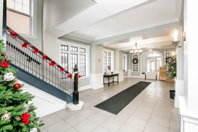 a hallway with wooden floor and stairs