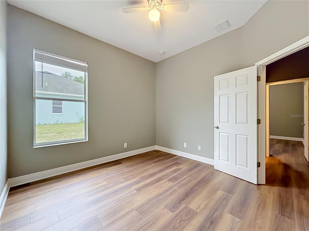 28549 Shirley Shores Road Tavares, FL 32778 - Photo 31 of 65 wooden floor in an empty room with a window