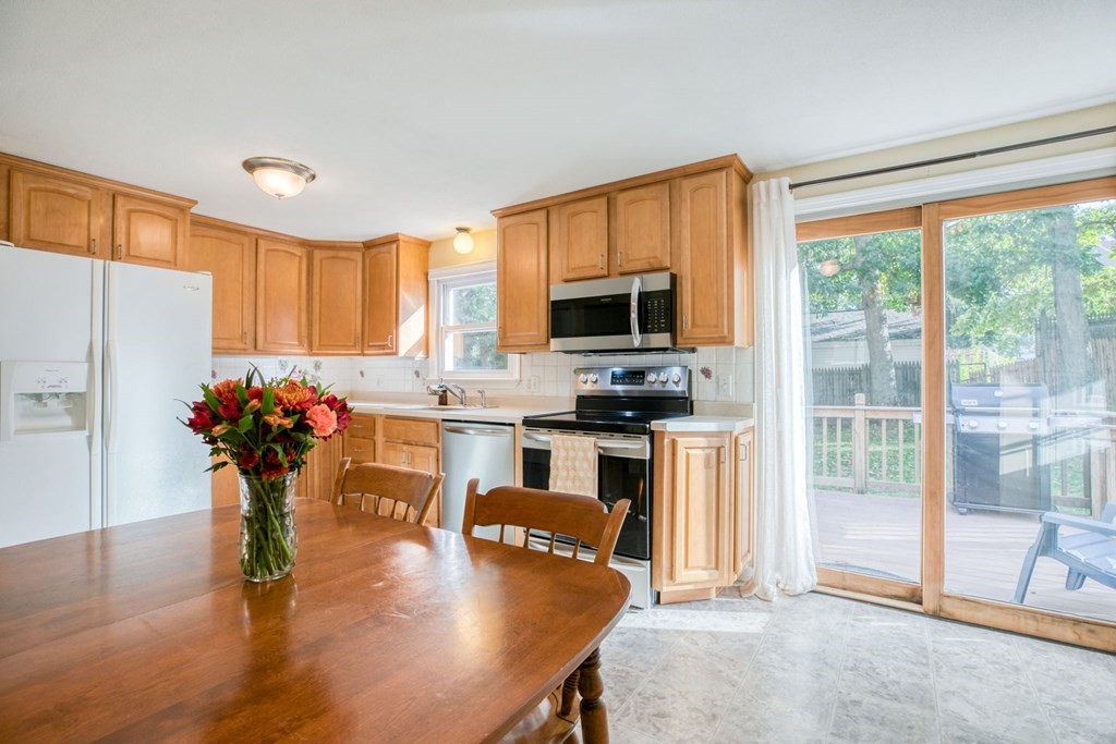 67 Aspen Road Springfield, MA 01128 - Photo 5 of 25 a kitchen with stainless steel appliances granite countertop a refrigerator sink stove microwave and cabinets