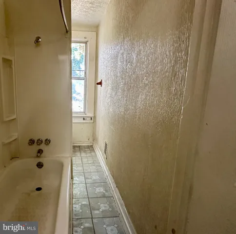 a bathroom with a bathtub and shower