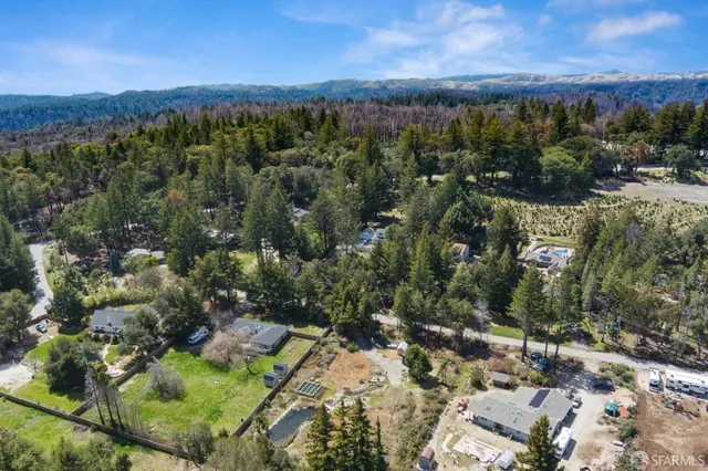 an aerial view of a houses with a yard