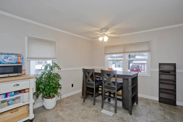 a view of a dining room with furniture and a potted plant